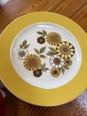 Premiere PremStone  12” chop plate in pattern Festival 503.  Yellow floral.